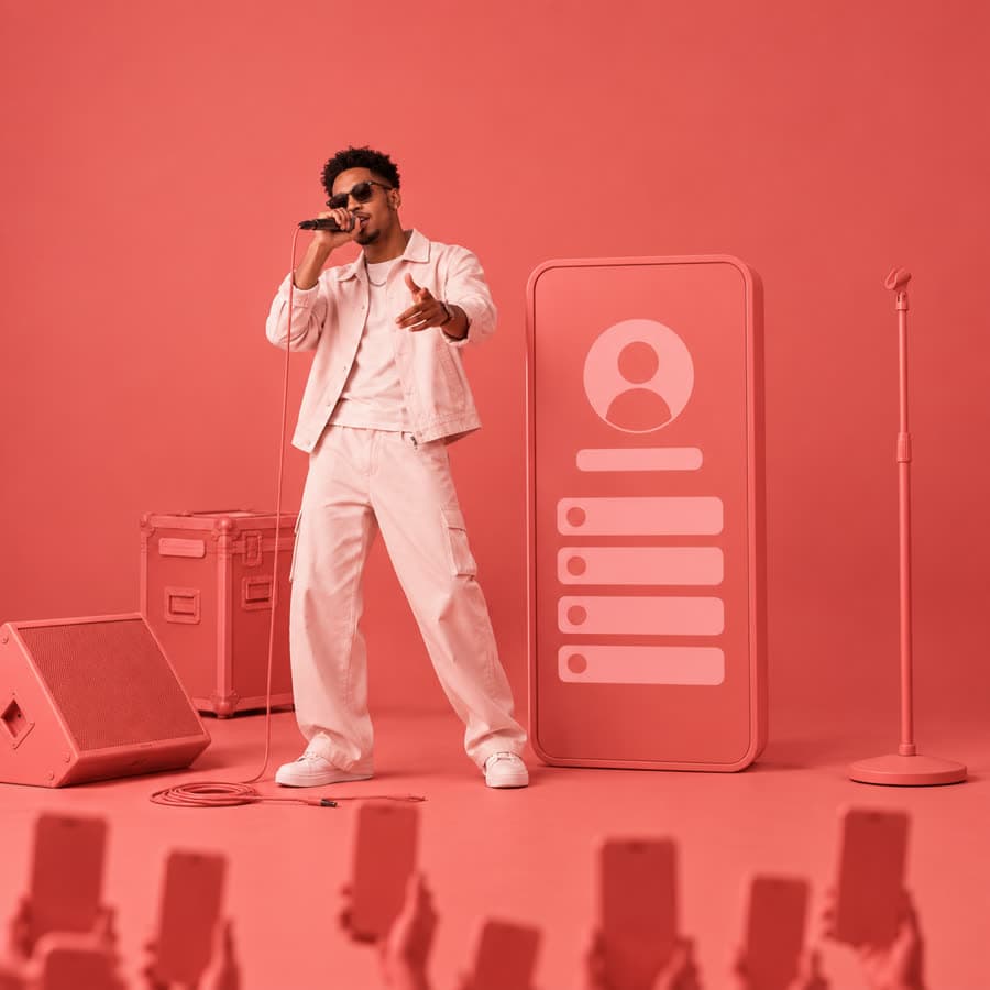 A performer on stage beside a life-size phone showing his Faciey profile